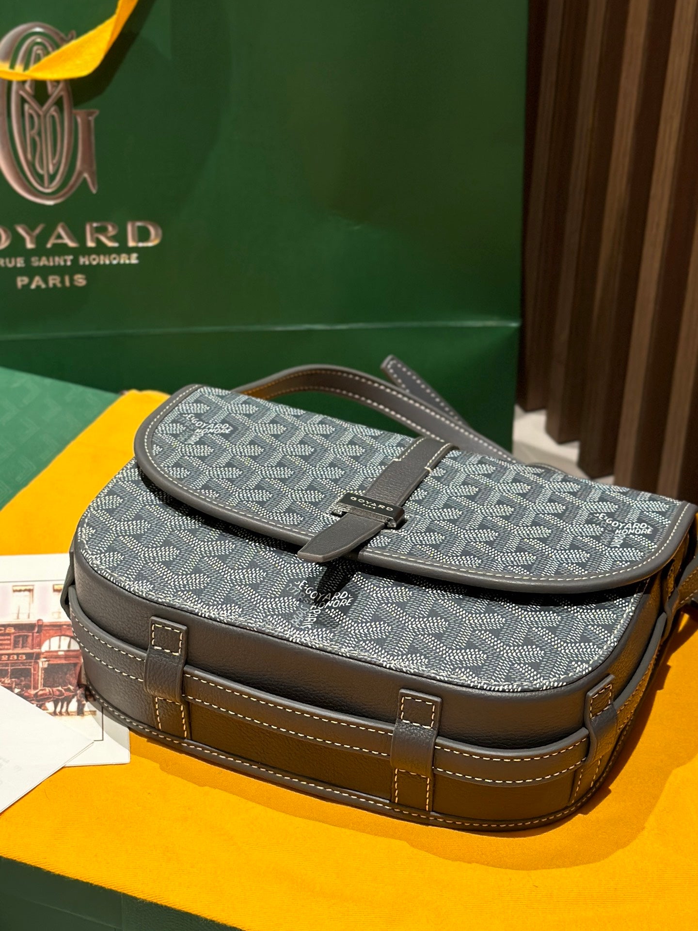 Goyard satchel-style bag with top flap, monogram pattern, and structured brown trim
