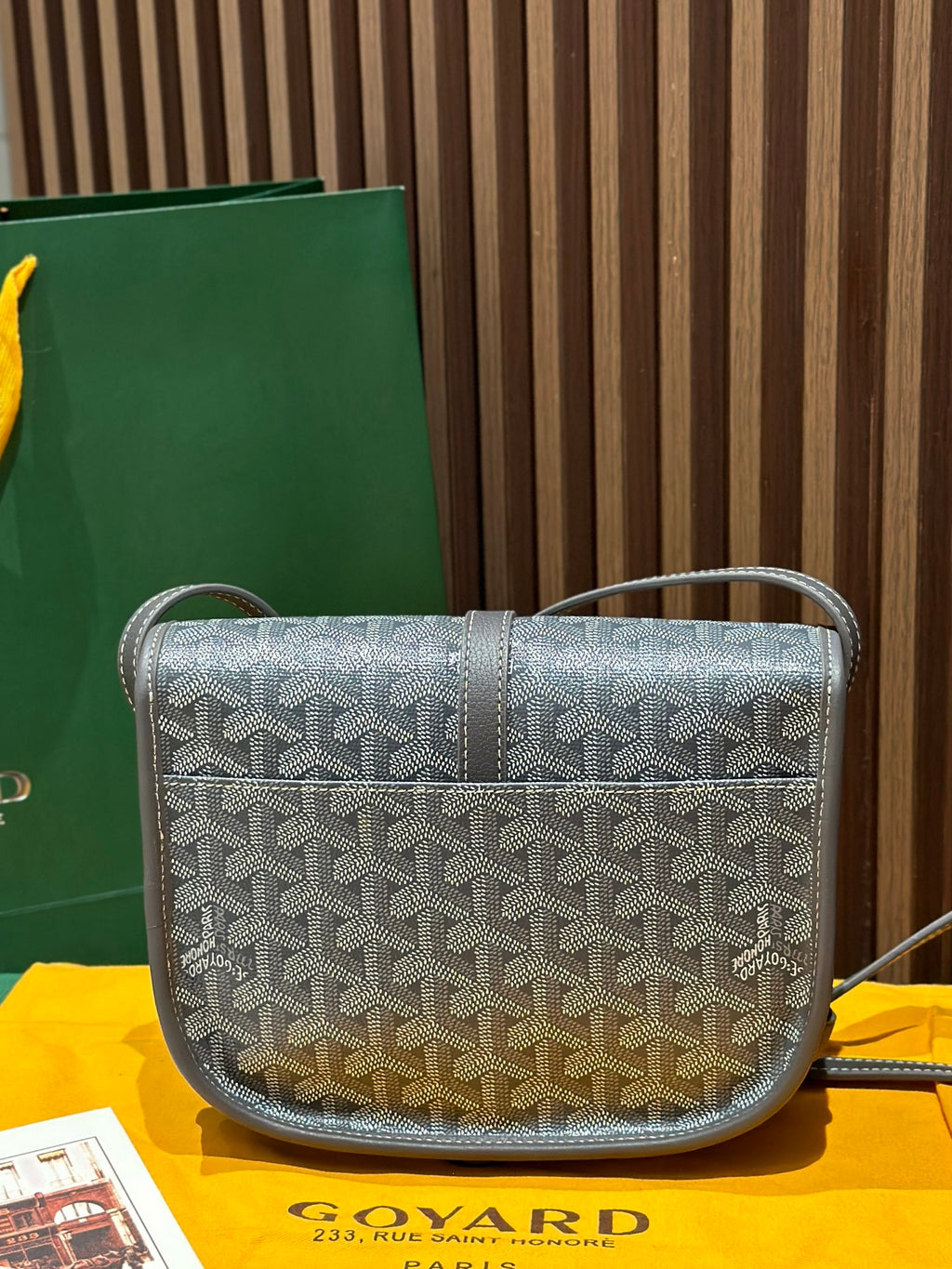 Goyard crossbody bag with monogram pattern, front flap, and short shoulder strap