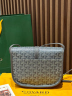 Goyard crossbody bag with monogram pattern, front flap, and short shoulder strap