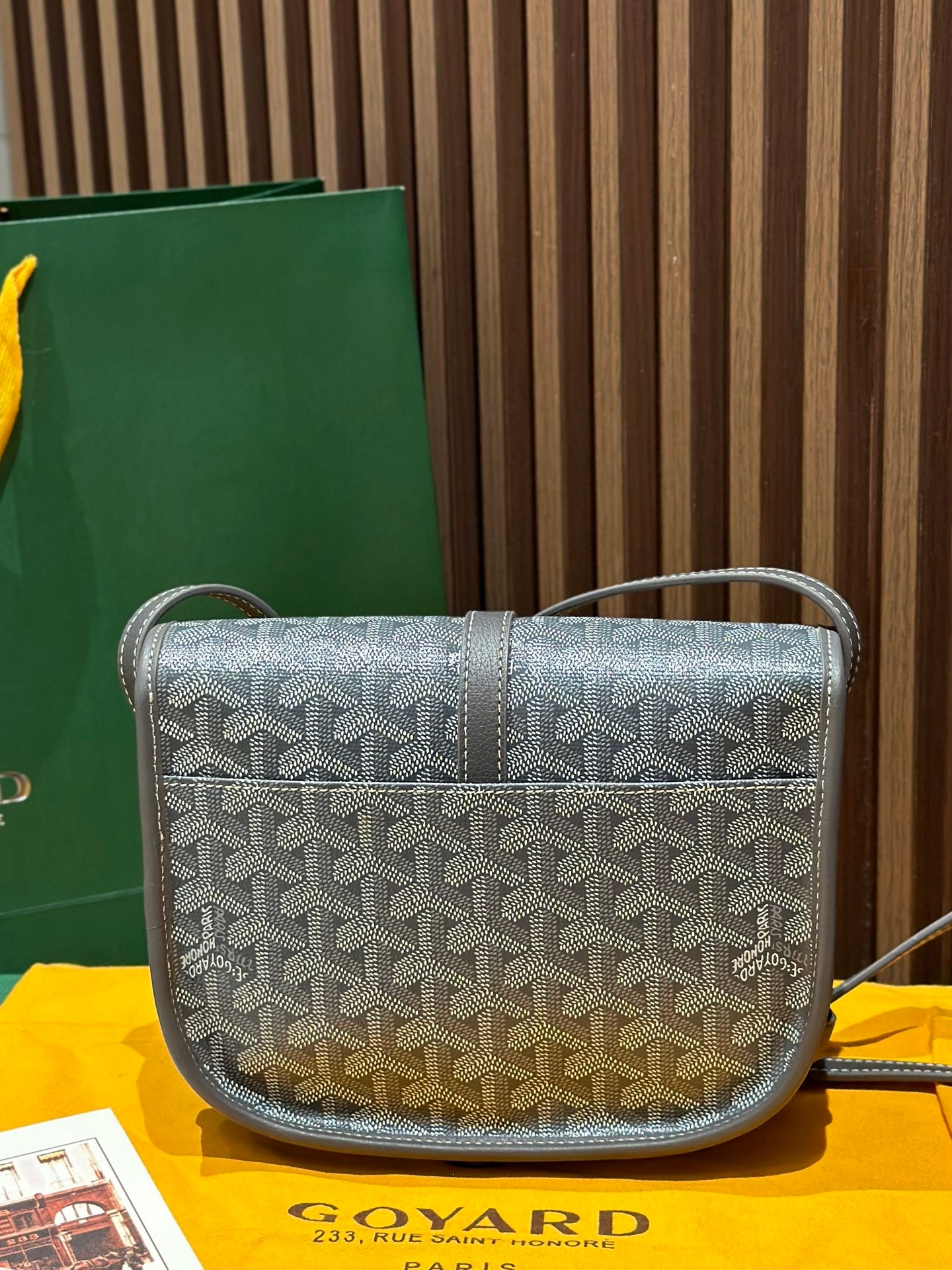 Goyard crossbody bag with monogram pattern, front flap, and short shoulder strap