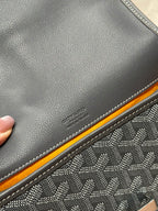 Goyard bag close-up of textured leather, contrast trim, and stitched edge