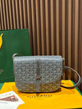 Goyard crossbody bag with patterned flap, brown trim, and adjustable shoulder strap