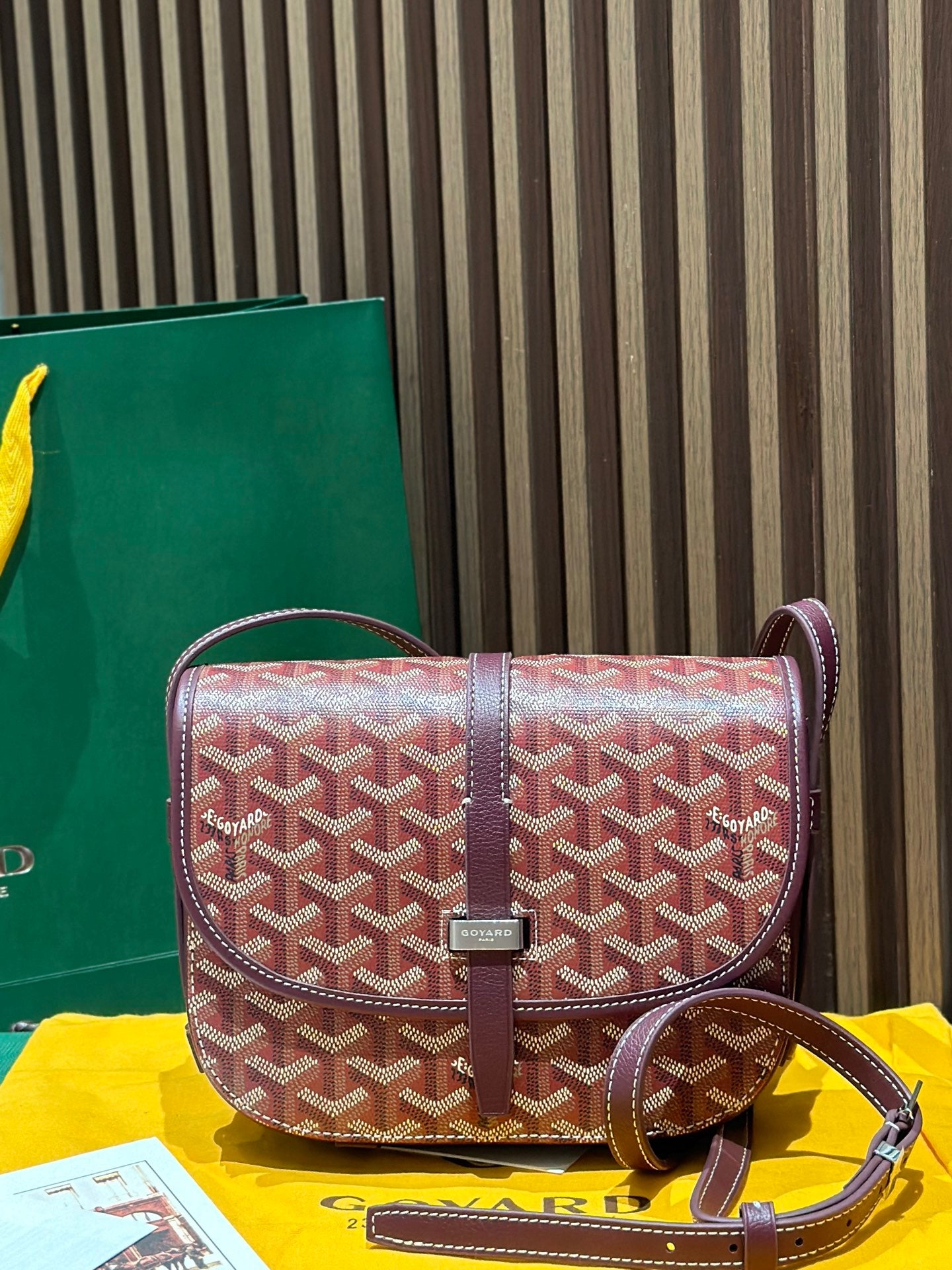 Goyard crossbody bag with maroon leather trim and red patterned Goyardine flap