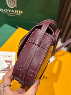 Goyard small bag with maroon pebbled leather front, top strap and stitched panels