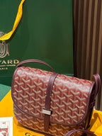 Goyard shoulder bag with red-and-white monogram pattern and maroon handle straps
