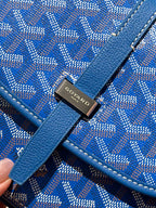 Goyard bag logo hardware on blue leather strap over monogram fabric