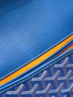 Blue leather trim and monogram fabric detail on a Goyard bag