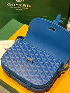 Goyard bag in blue with monogram fabric, flap closure, and leather trim details