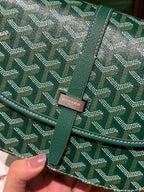 Goyard patterned flap crossbody bag closeup with logo patch and green leather trim