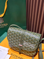 Small green crossbody bag with Goyardine pattern, front flap clasp, and side strap view.