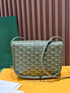 Green Goyardine crossbody bag with repeating pattern, flap closure, and shoulder strap.