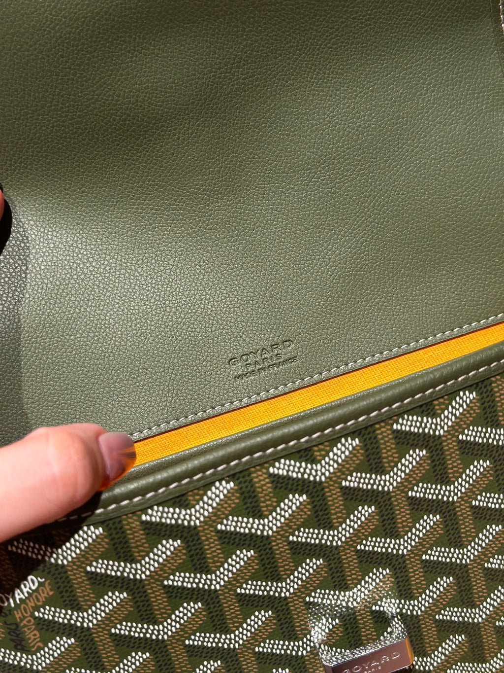 Embossed Goyard logo on olive leather corner trim with patterned canvas edge.