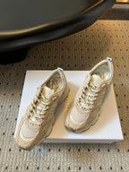 Dior unisex sneakers pair view, cream and sand uppers with metallic gold laces