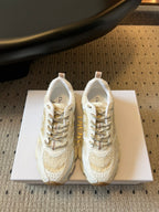 Dior unisex sneakers in white with gold accents, lace-up with textured panels