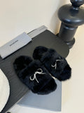 Balenciaga plush black slide sandals with rhinestone bow strap accents