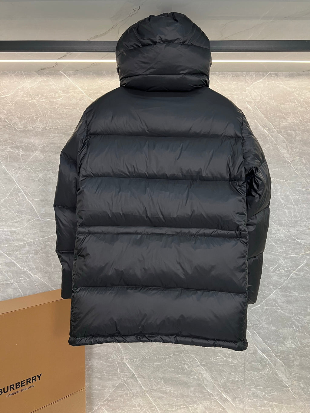 Burberry long puffer jacket with hood, dark quilted back view with horizontal baffle seams