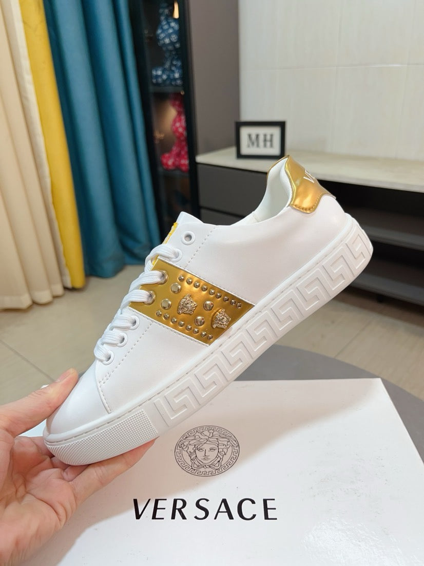 White leather sneakers with gold stripe, gold collar lining, and textured sole