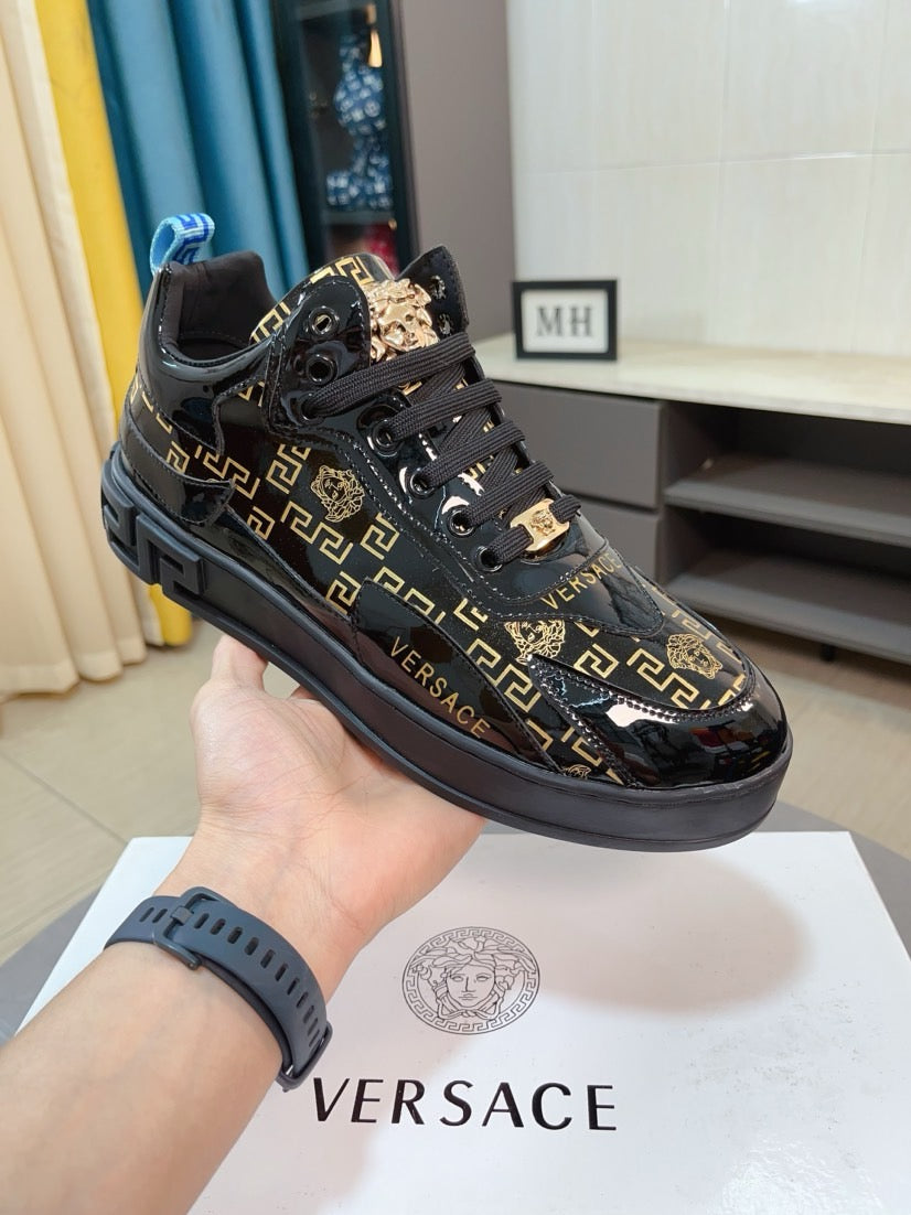 Black Versace high-top sneakers with gold Greca pattern and lion emblem on the tongue
