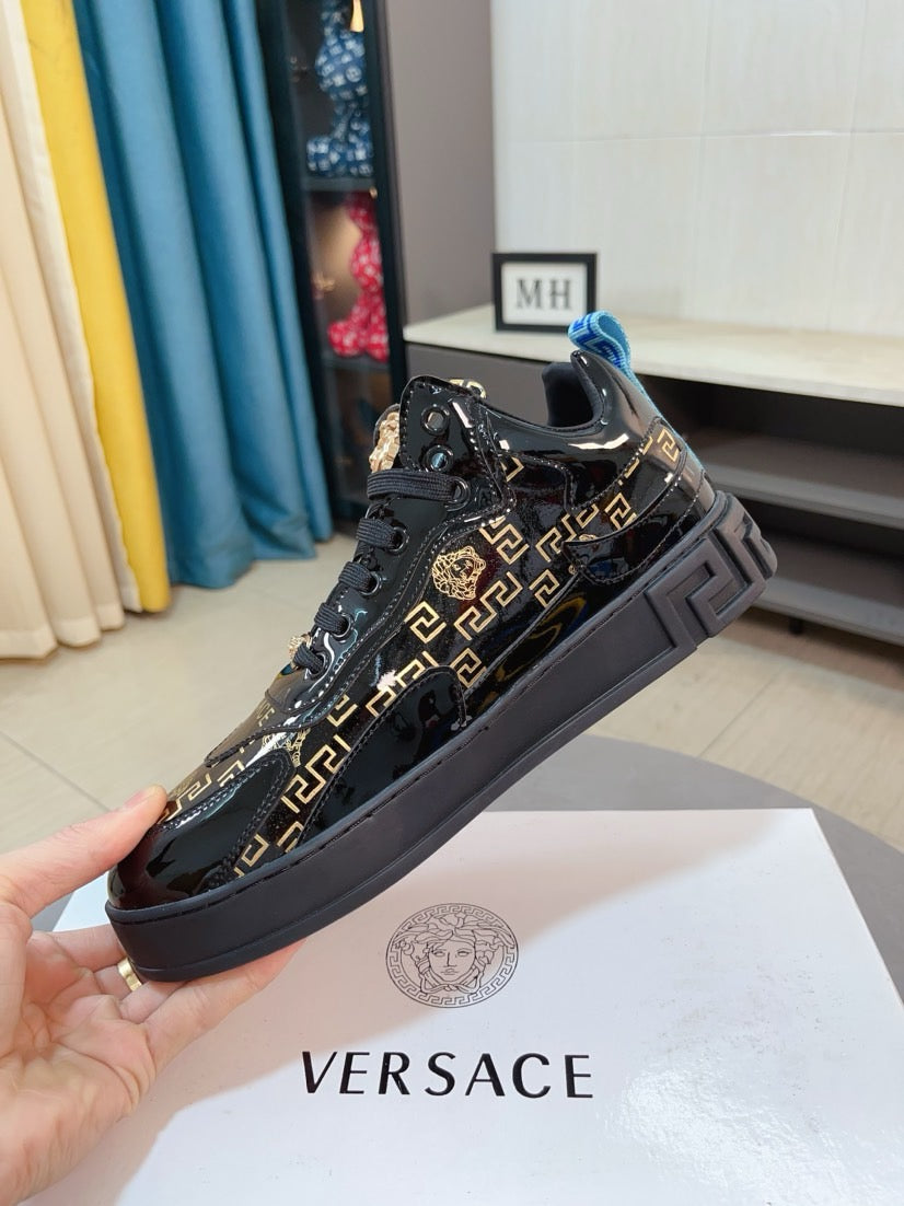 Black Versace high-top sneakers with gold Greca print and blue heel detail, lace-up