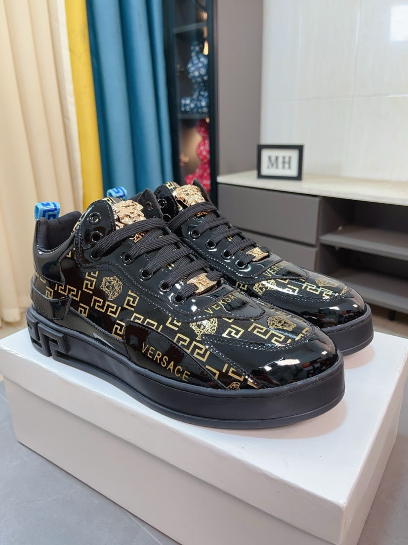 Black Versace high-top sneakers with gold Greca logos, wide black sole and front laces