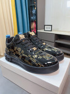 Black Versace high-top sneakers with gold Greca logos, wide black sole and front laces