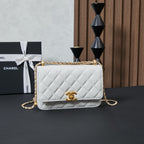 White quilted Chanel shoulder bag with gold chain and front CC logo flap