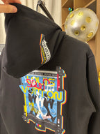Black hoodie sleeve with colorful graphic and vertical logo patch