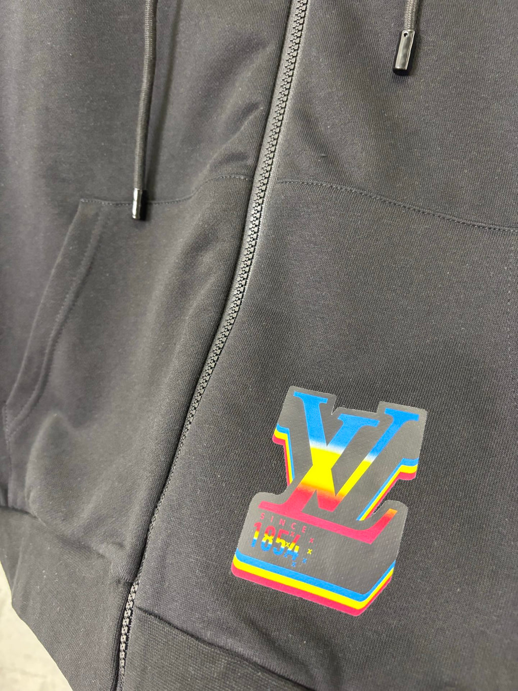 Black hoodie front zipper with colorful LV-style graphic patch