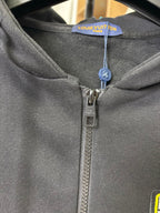 Black zip-up hoodie neckline with Louis Vuitton label and metal zipper pull