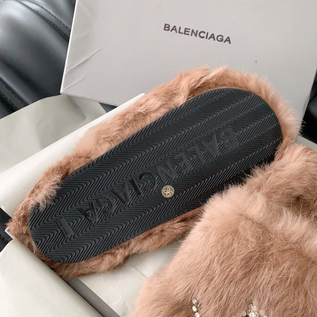 Balenciaga faux-fur slide sandal showing patterned rubber outsole with small logo
