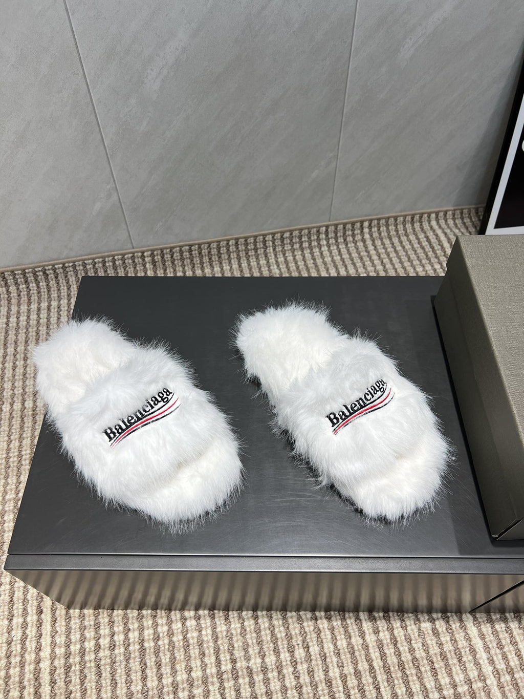White fur slide sandals, side view with Balenciaga logo straps