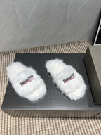 White fur slide sandals, side view with Balenciaga logo straps