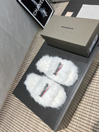 White fur slide sandals with crossed straps and Balenciaga logo