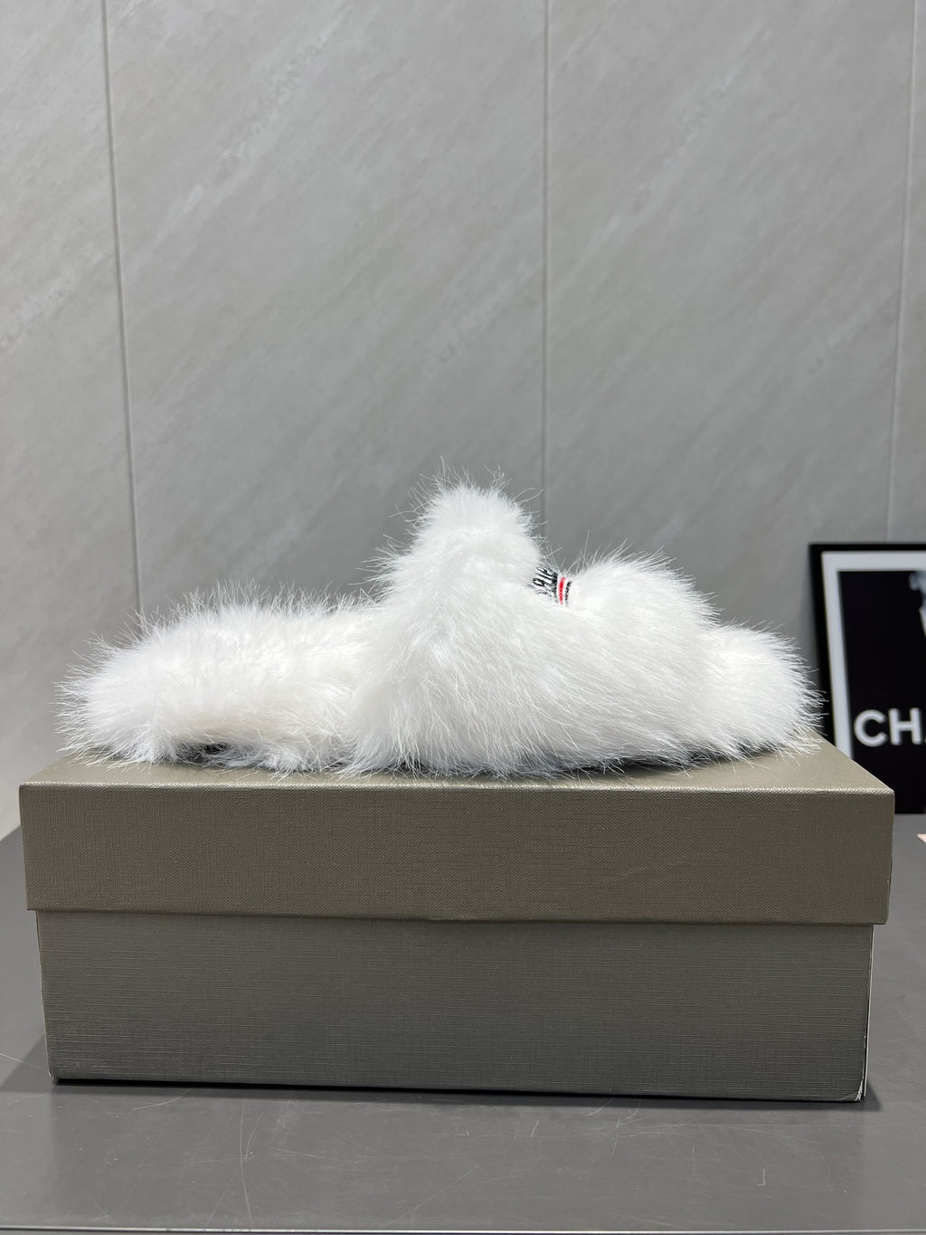 White fur slide sandal on box with Balenciaga logo