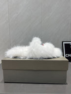White fur slide sandal on box with Balenciaga logo