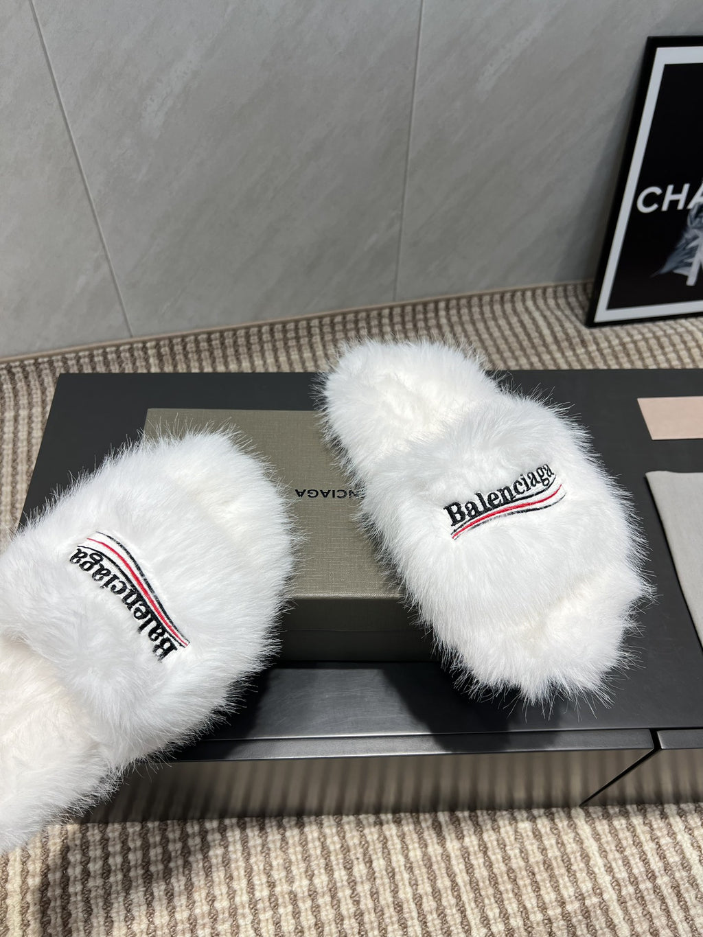 White fur slide sandals close-up with Balenciaga logo straps