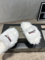 White fur slide sandals close-up with Balenciaga logo straps