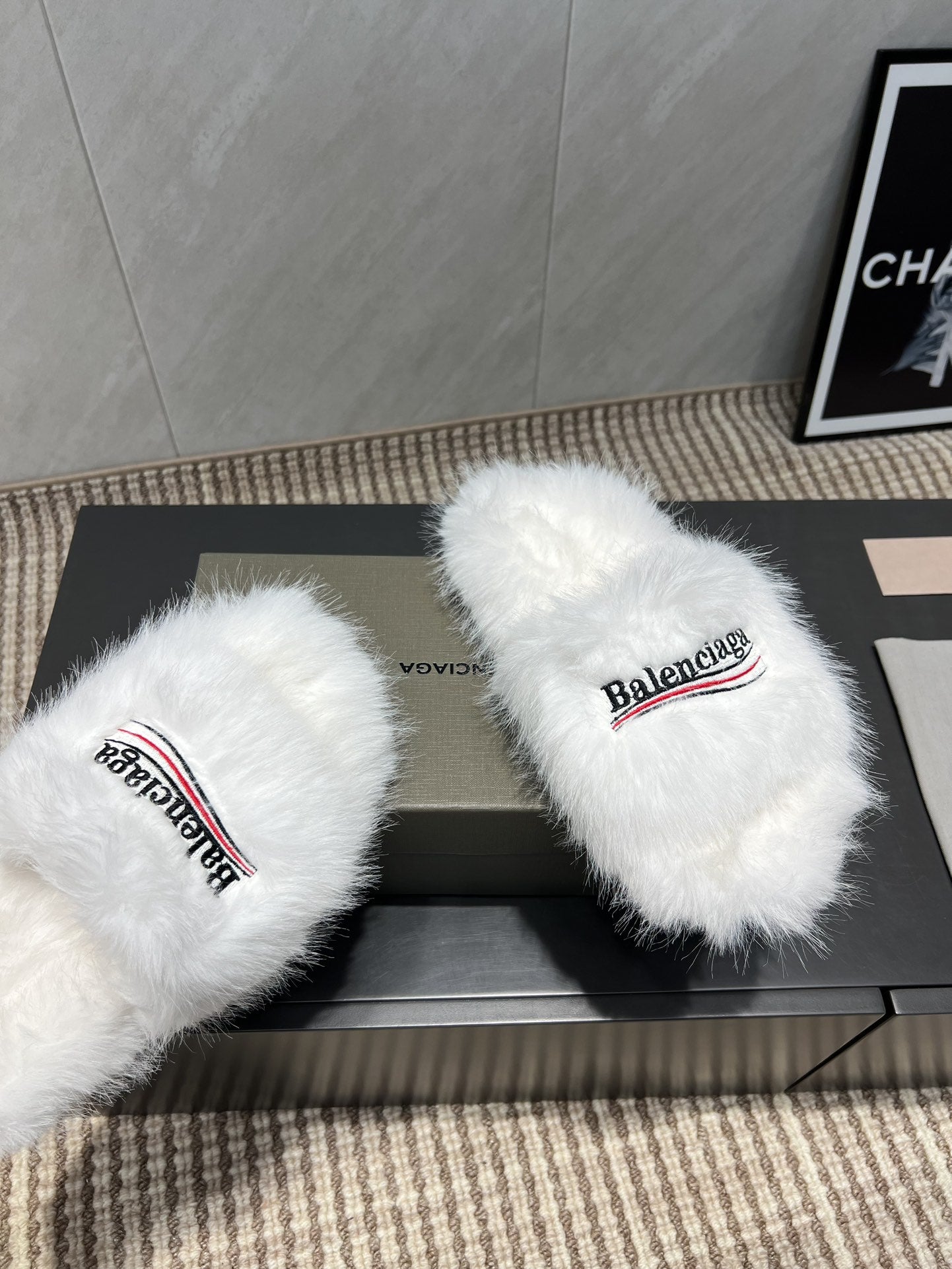 White fur slide sandals close-up with Balenciaga logo straps
