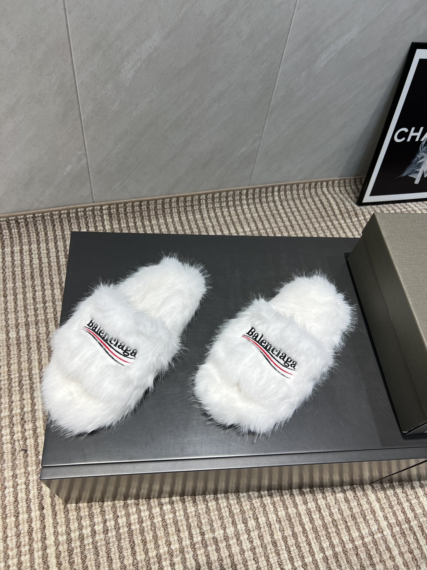 White fur slide sandals with Balenciaga logo straps, front angle