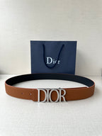 Tan leather Dior belt with rectangular engraved buckle on a flat strap.