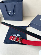 Dior red leather belt laid flat with gold-tone “DIOR” buckle