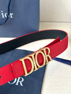 Dior belt close-up: red strap with gold “DIOR” buckle
