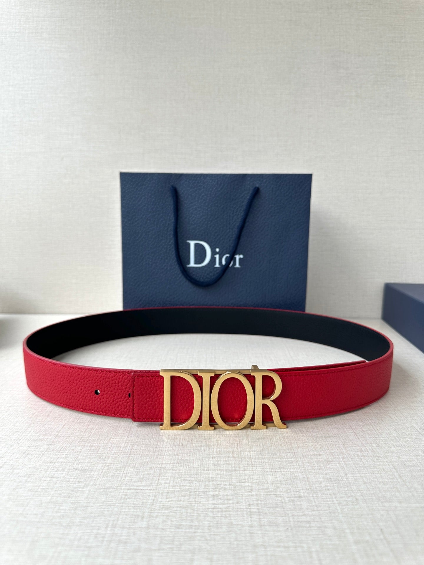 Dior red leather belt with gold-tone “DIOR” buckle