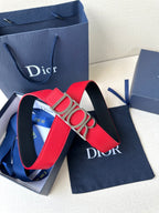 Dior belt close-up: red strap with gold “DIOR” buckle