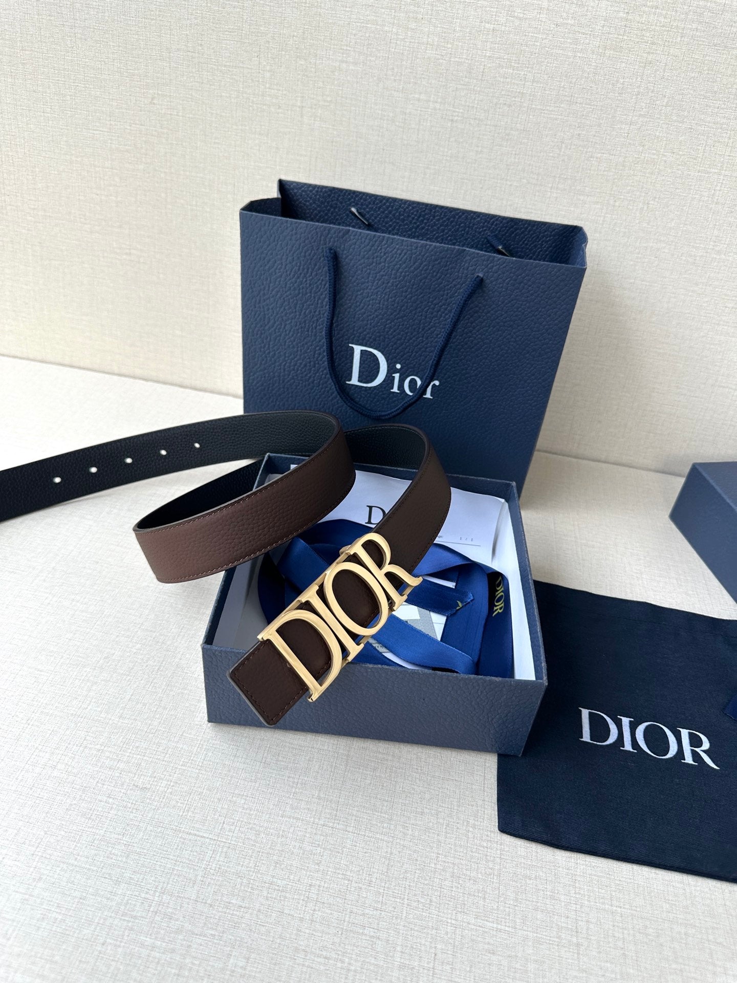 Brown leather belt with gold Dior buckle and punched holes