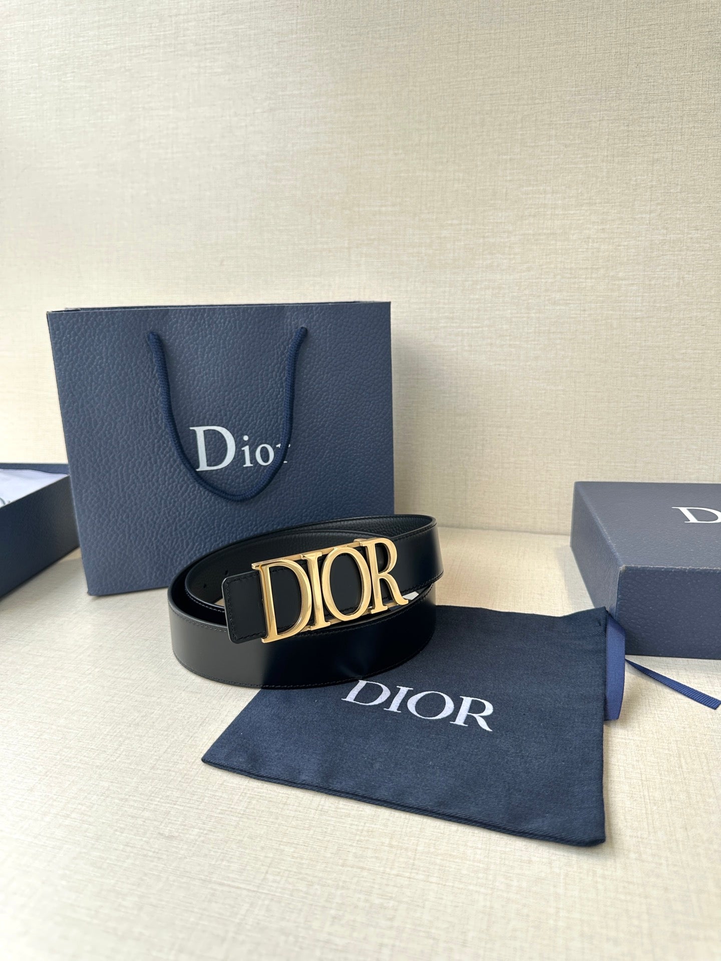Black leather Dior belt with gold-tone Dior buckle and Dior strap lettering