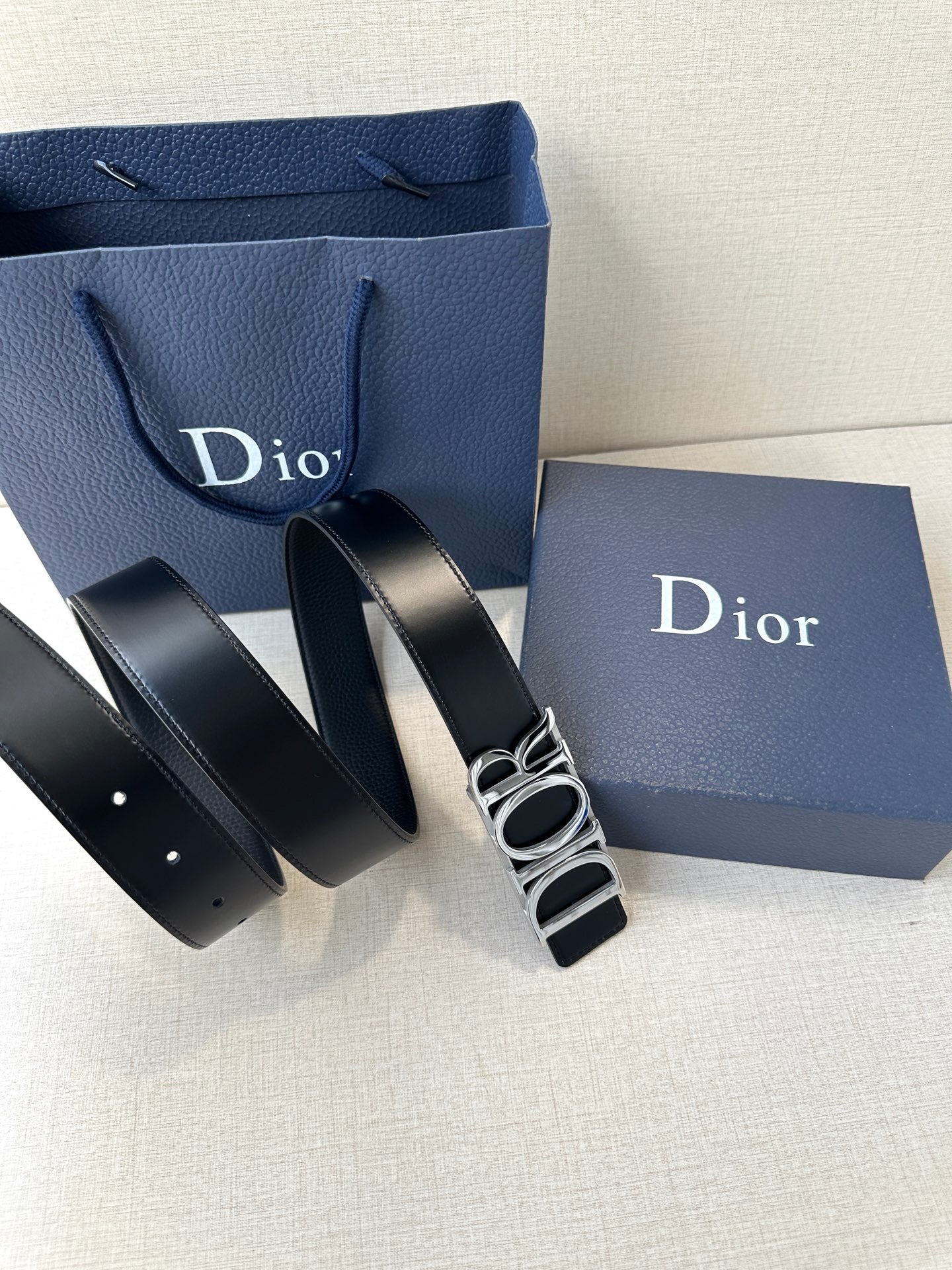Black leather Dior belt with prong buckle and stacked Dior logo detail