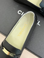 Black loafer insole view with gold Chanel text and gold-trimmed strap