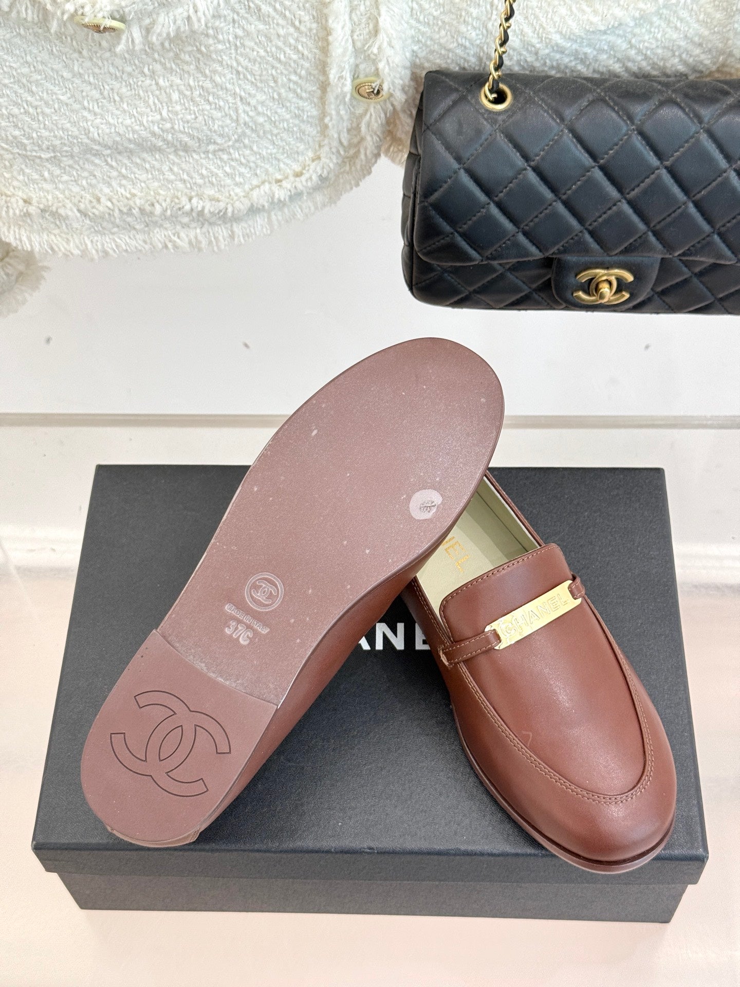 Women’s brown loafer with gold buckle bar and light outsole view