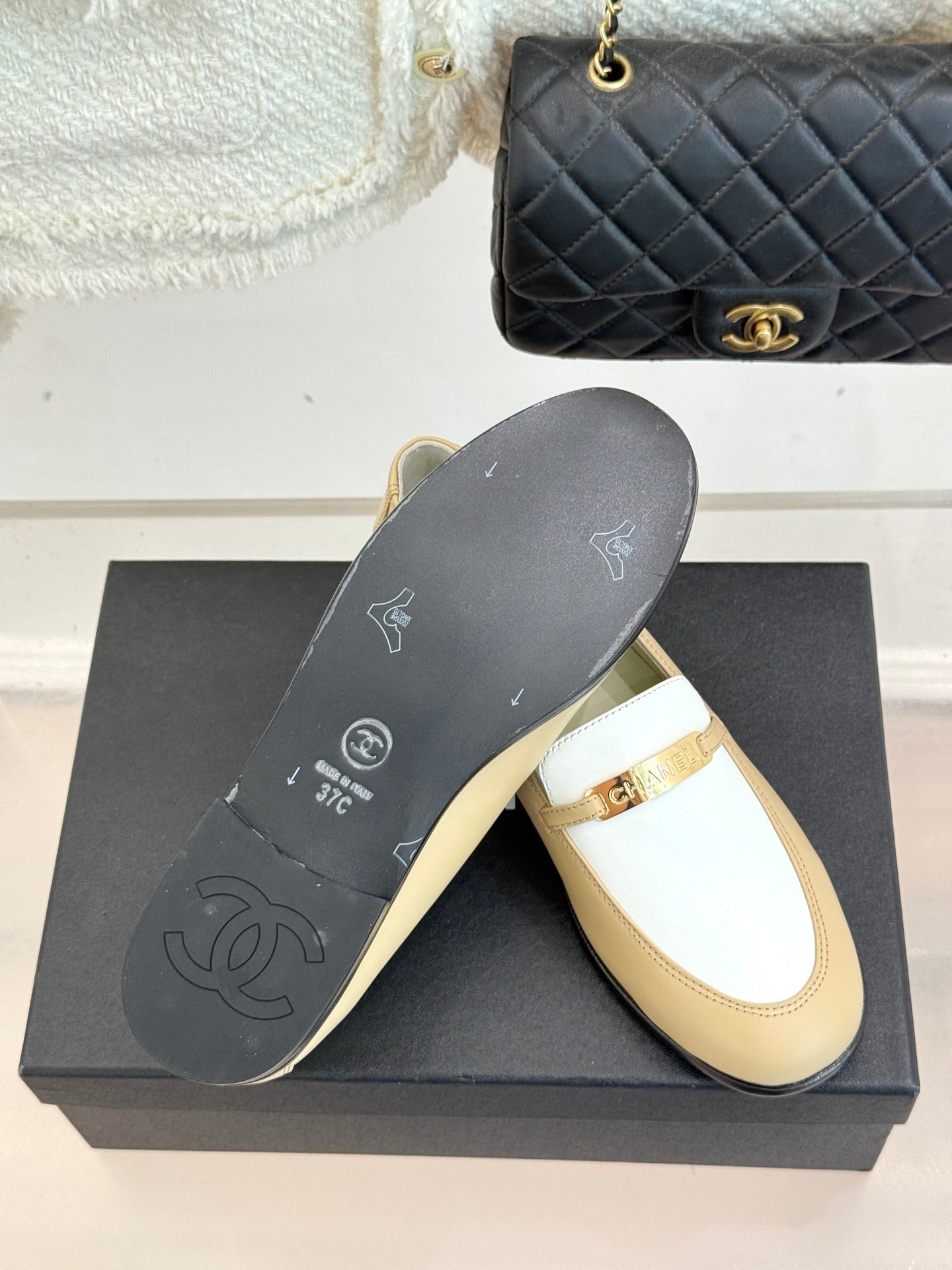 Chanel women's loafer outsole and top, cream leather with white strap and gold buckle